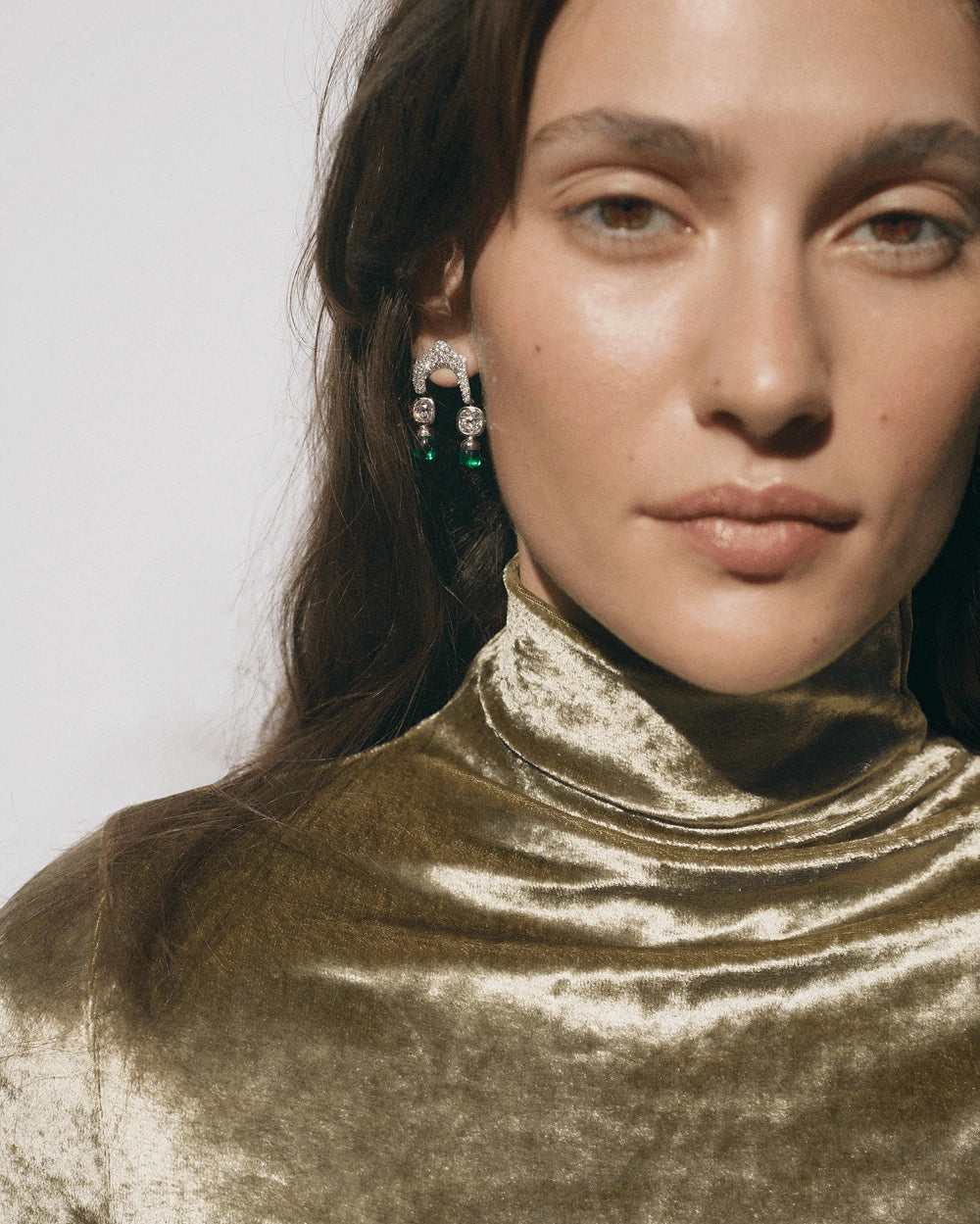Model wearing pavé and emerald drop earrings